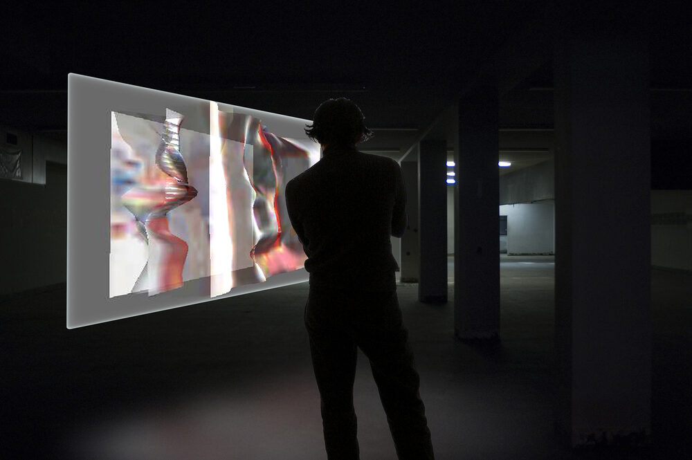 A silhouetted figure standing before a large illuminated projection screen showing distorted, glitching imagery, in a dim underground space.